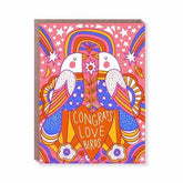Front of card reads: "CONGRATS LOVE BIRDS." Card shows two birds facing each other surrounded by colorful hearts, rainbows, stars and flowers. Designed by Hello! Lucky and made in San Francisco, CA. measures 4.25 x 5.5.