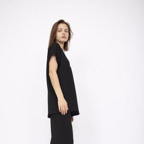 Flowy short sleeve tunic top in Black with a left side slit. Fabric and top made in Los Angeles, CA by Corinne Collection.