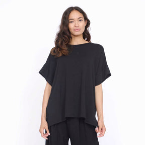 Oversized tunic style top with side slits. The Eleanor Tunic in Black is designed by Corinne Collection and made in Los Angeles, CA.
