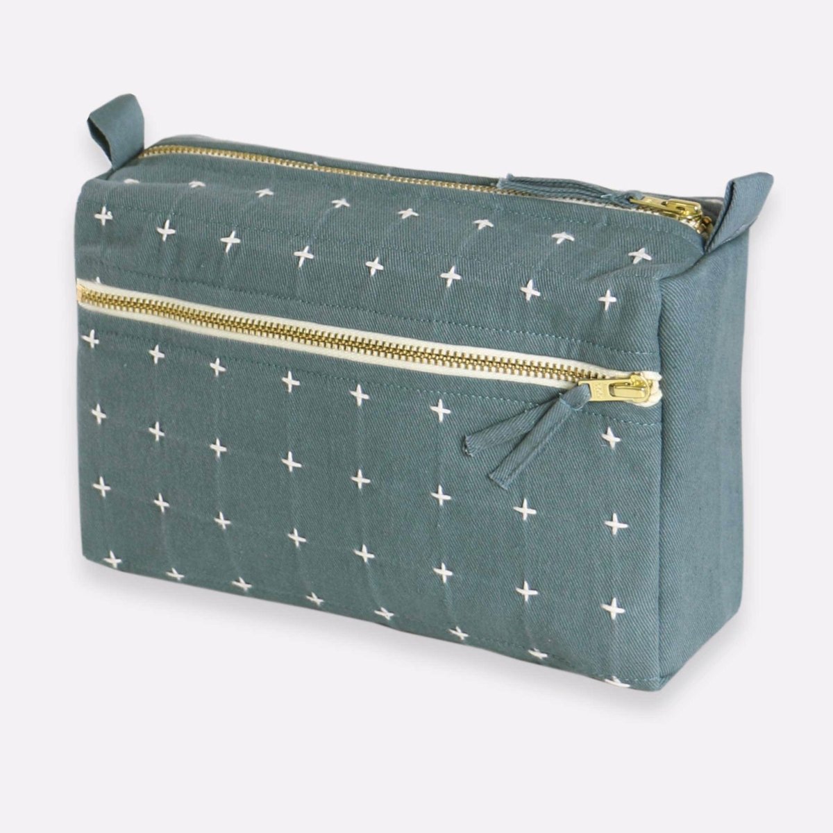 Square cross-stitch toiletry bag with side and top zipper in the shade Spruce. Designed by Anchor in Louisville, Kentucky and handmade in Ajmer, India.