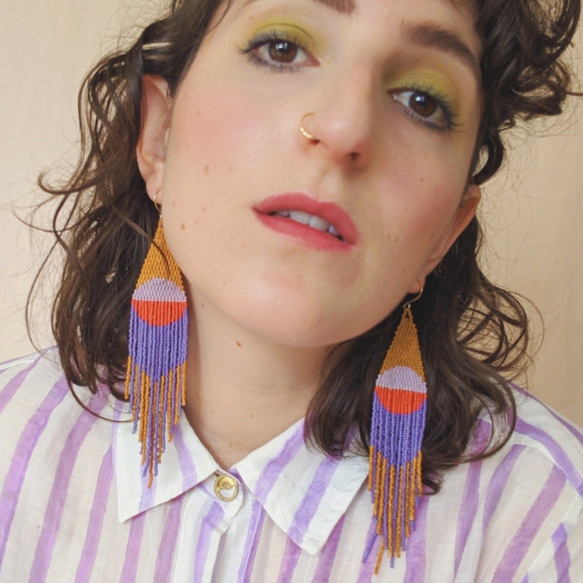 Orange, red and purple woven beaded fringe earrings. Designed and handmade by Take Shape Studio in Berkeley, California.