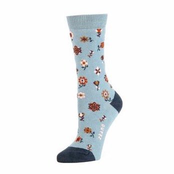 Light blue sock with red, pink and white floral pattern with the Zkano logo along the arch. Heel and toe are a navy blue. The Ditsy Floral Crew Sock in Lead is from Zkano and made in Alabama, USA.