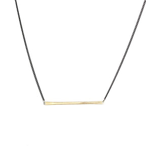 betsy & iya necklace with gold brass bar and black chain.