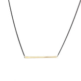 betsy & iya necklace with gold brass bar and black chain.