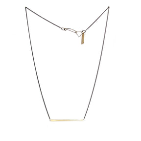 betsy & iya Divisionary necklace with gold brass bar and black chain.