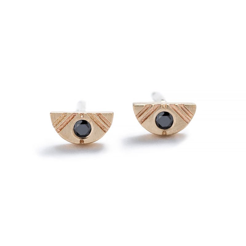 Tiny, half-moon stud earrings of 14k yellow gold with round, black diamond inlays, and 14k gold earring posts. Hand-crafted in Portland, Oregon.