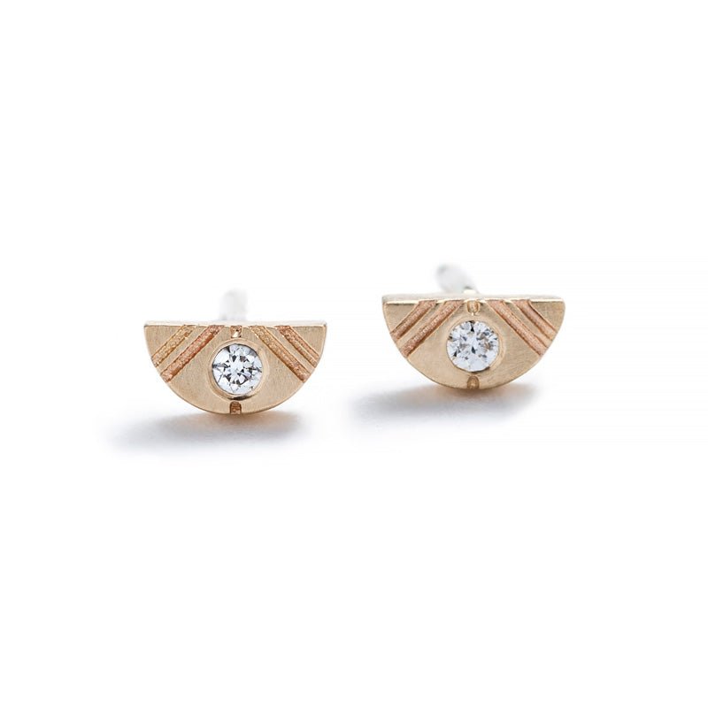 Tiny, half-moon stud earrings of 14k yellow gold with round, white diamond inlays, and 14k gold earring posts. Hand-crafted in Portland, Oregon.