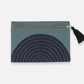 Spruce colored square pouch with black cross-stitched concentric pattern. Includes a zipper with a black tassel. Designed by Anchal in Louisville, Kentucky and handmade in Ajmer, India.