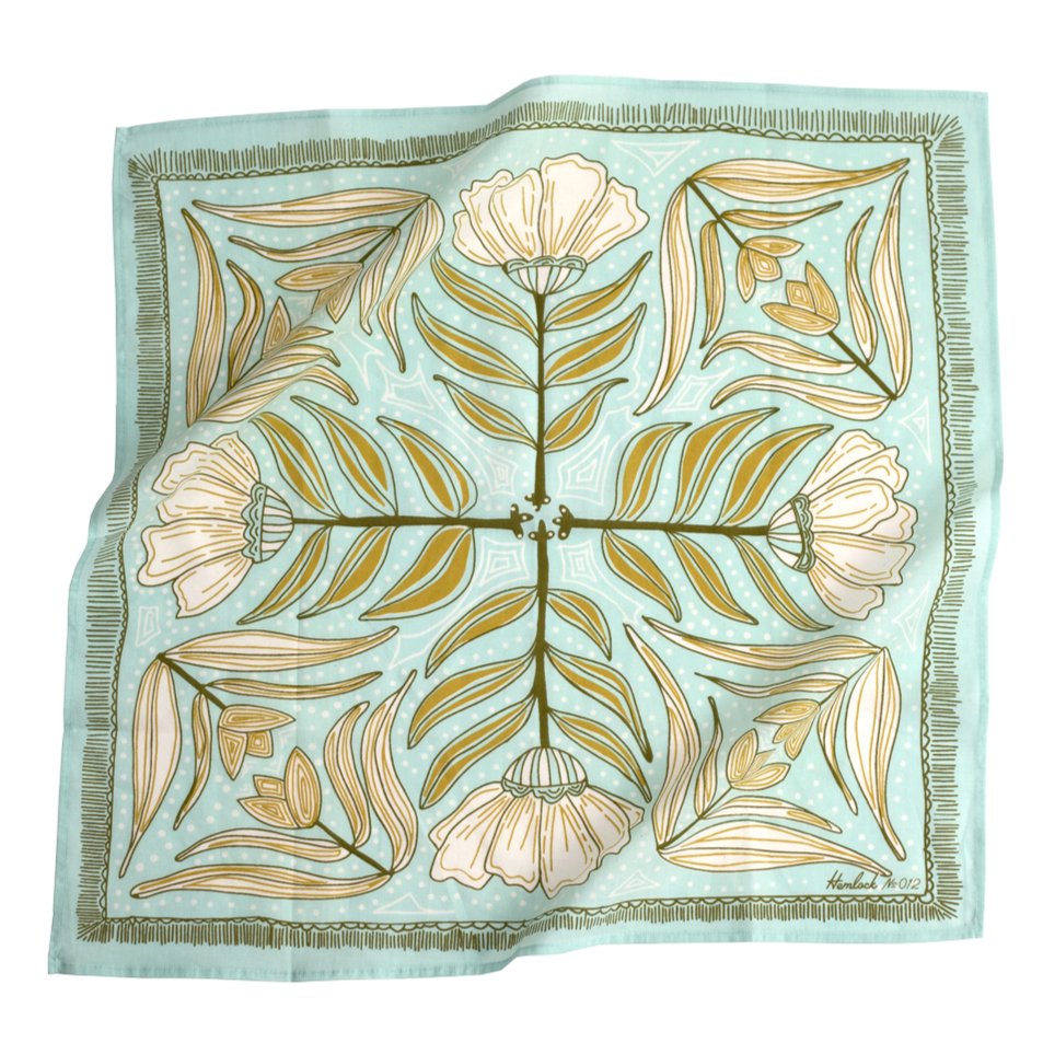A light blue bandana with a mirror image of a white and yellow/brown floral pattern. Designed by Hemlock Goods in Fulton, MO and screen printed by hand in India.
