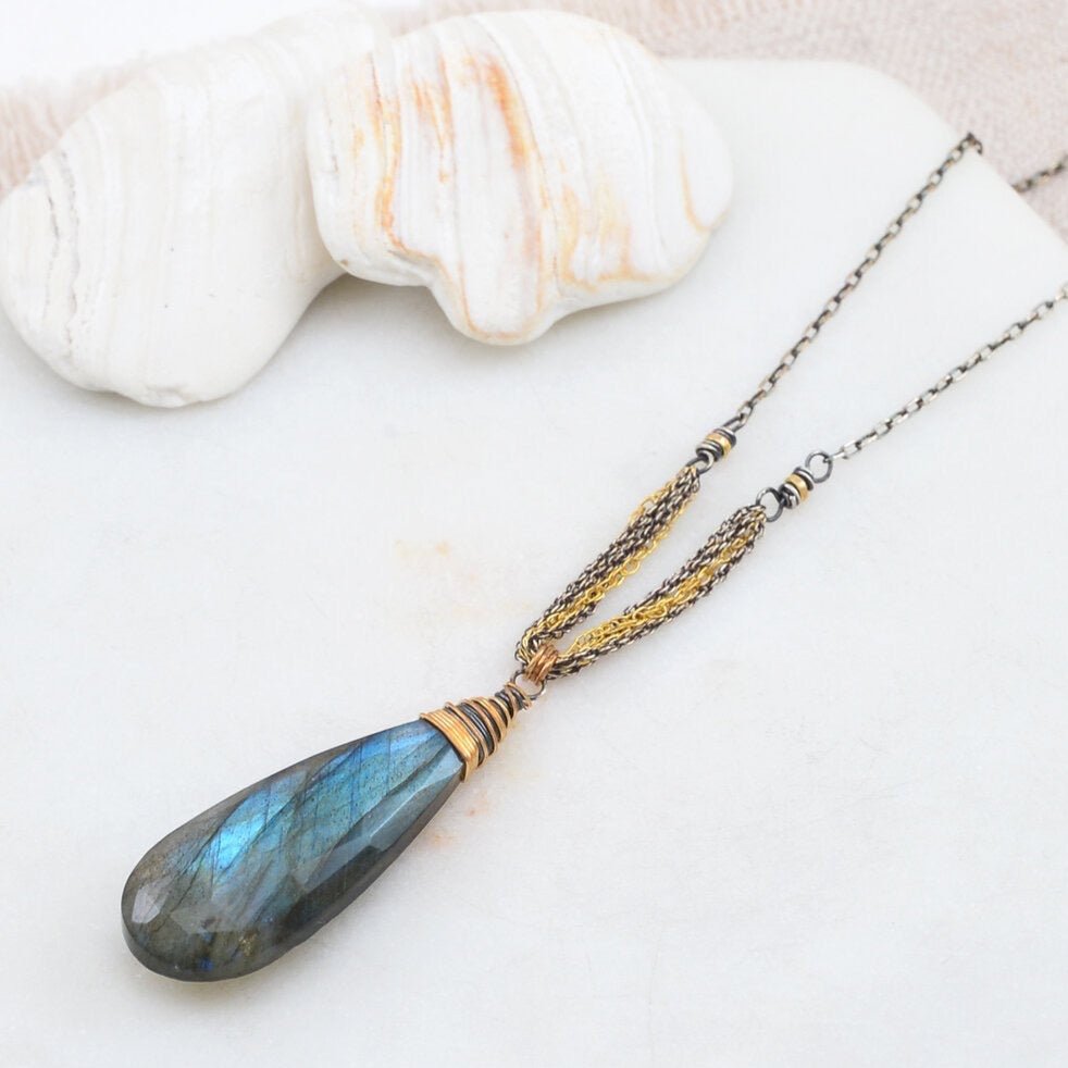 Teardrop shaped labradorite pendant necklace wrapped in sterling silver and gold-fill rope chains. The Ella Necklace in designed and handmade by Amy Olson in Portland, Oregon.