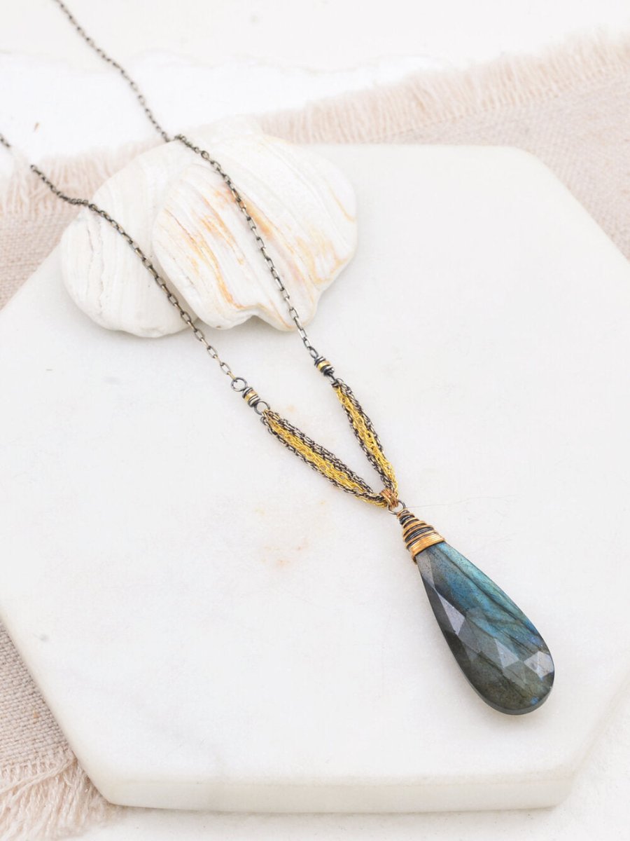 Teardrop shaped labradorite pendant necklace wrapped in sterling silver and gold-fill rope chains. The Ella Necklace in designed and handmade by Amy Olson in Portland, Oregon.