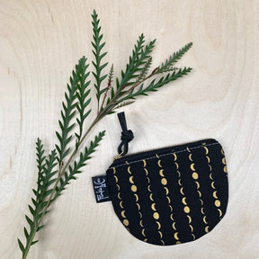 Moon inspired pattern pouch in black and gold. The pouch is a half-moon shape and features a zipper pull. Designed and crafted by Frankie & Coco in Portland, Oregon.