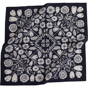 Black bandana with a mirror image of a white floral pattern. Designed by Hemlock Goods in Fulton, MO and screen printed by hand in India.