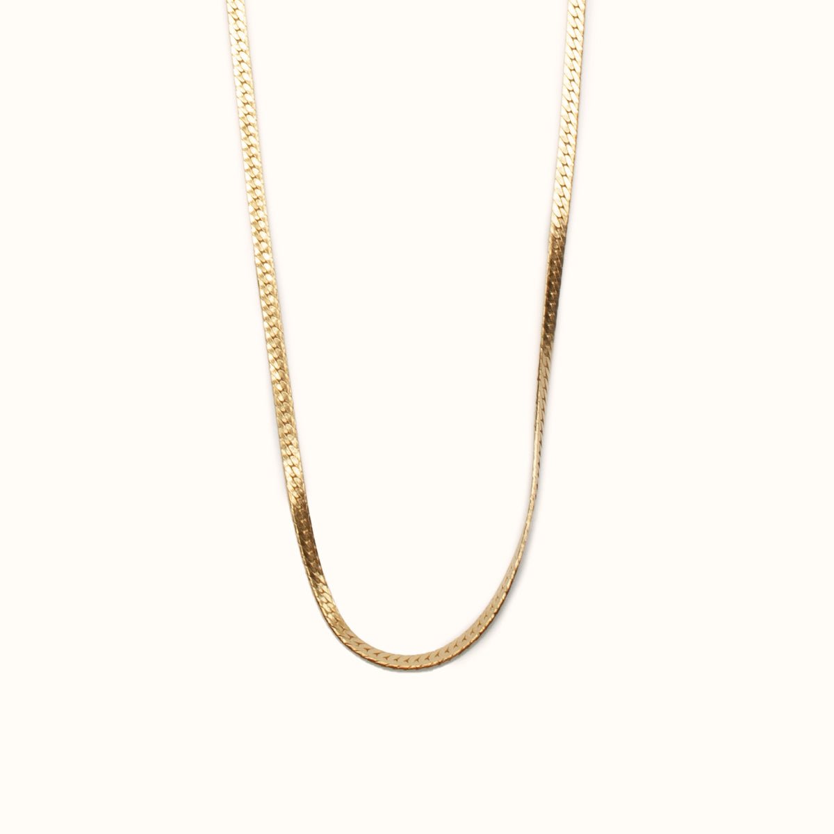 A classic gold tone herringbone necklace. The Bold Herra Necklace is handcrafted by Hello Adorn in Eau Claire, WI.