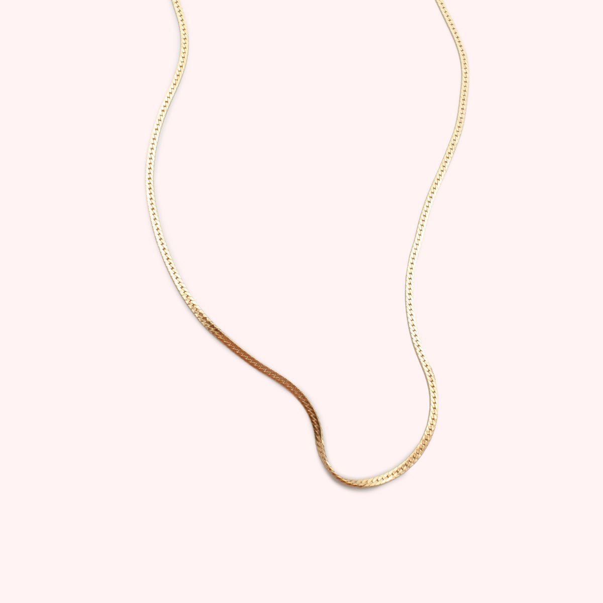 A delicate herringbone chain necklace in 14 karat gold fill. The Delicate Here is handcrafted by Hello Adorn in Eau Claire, WI.