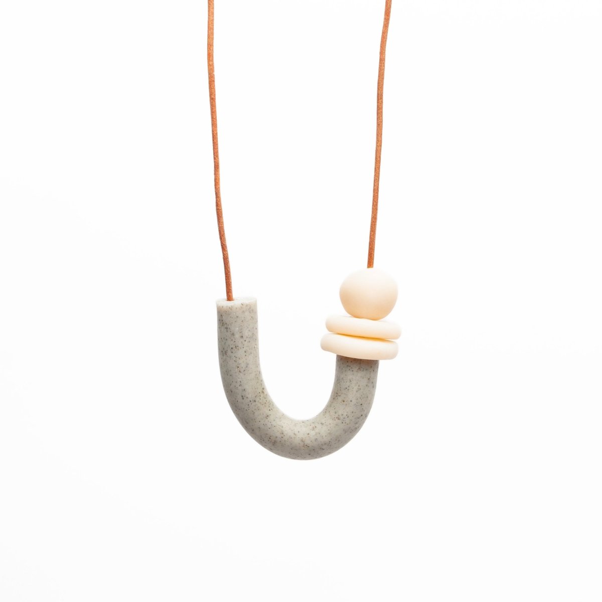 U shaped necklace made of polymer clay and orange leather cord. Made in Los Angeles, California by Hey Moon Designs.
