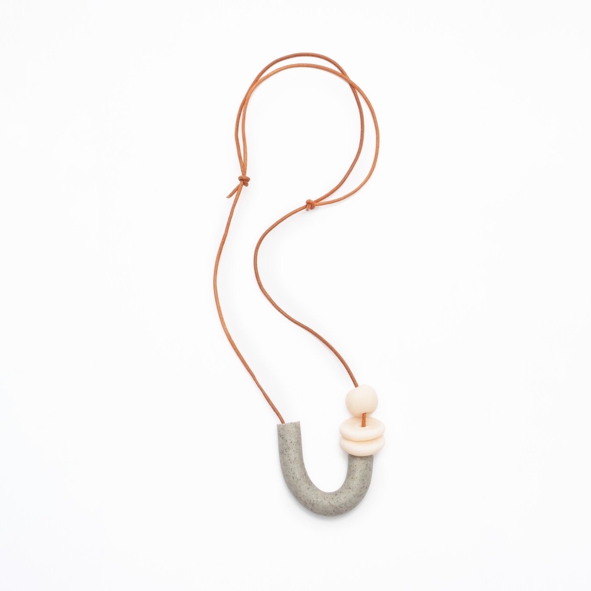 U shaped necklace made of polymer clay and orange leather cord. Made in Los Angeles, California by Hey Moon Designs. 
