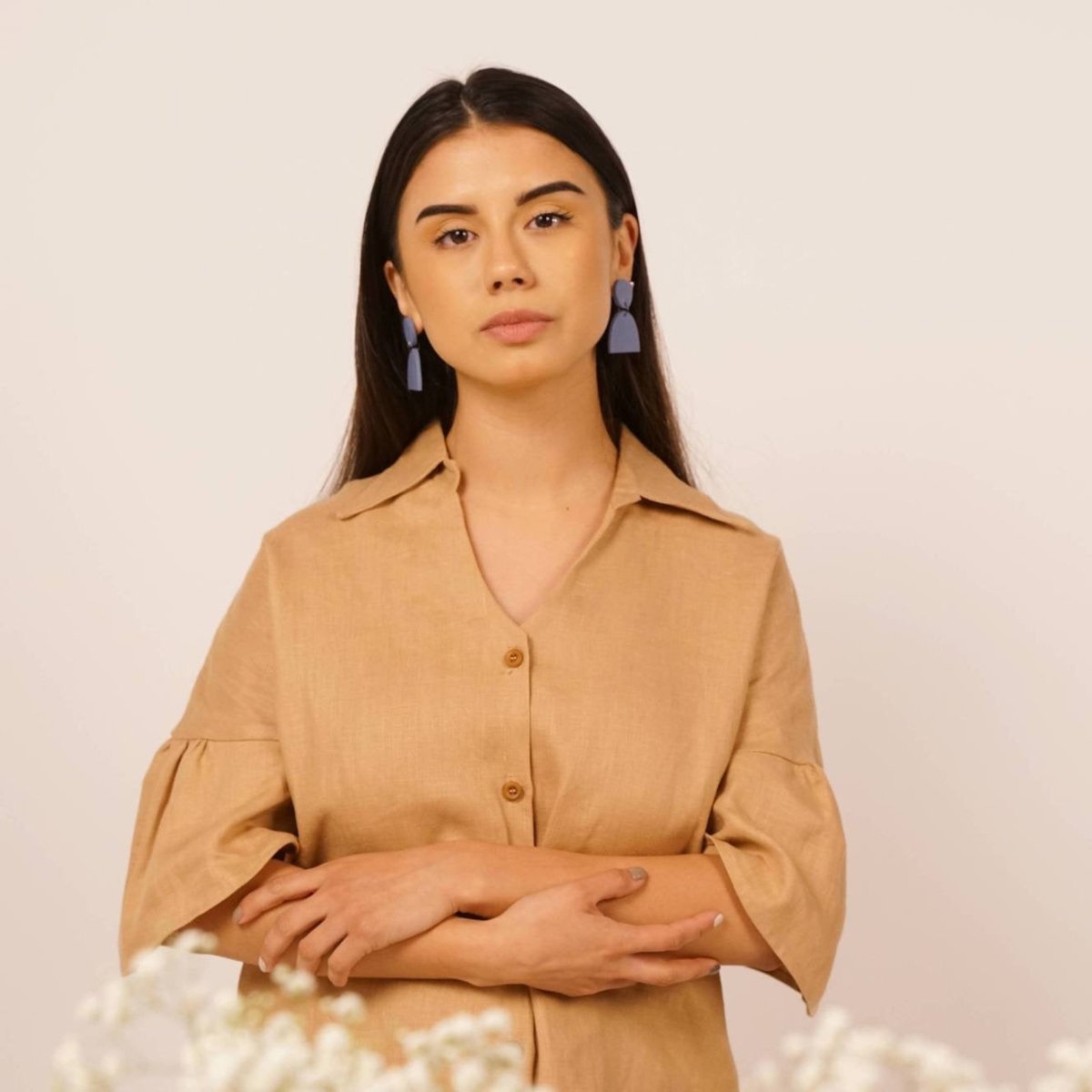 Aries earrings in the shade sky. Flat circle top piece joined by a a separate half-moon shaped bottom piece. Displayed on a model with dark brown hair. Made in Los Angeles, California by Hey Moon Designs.