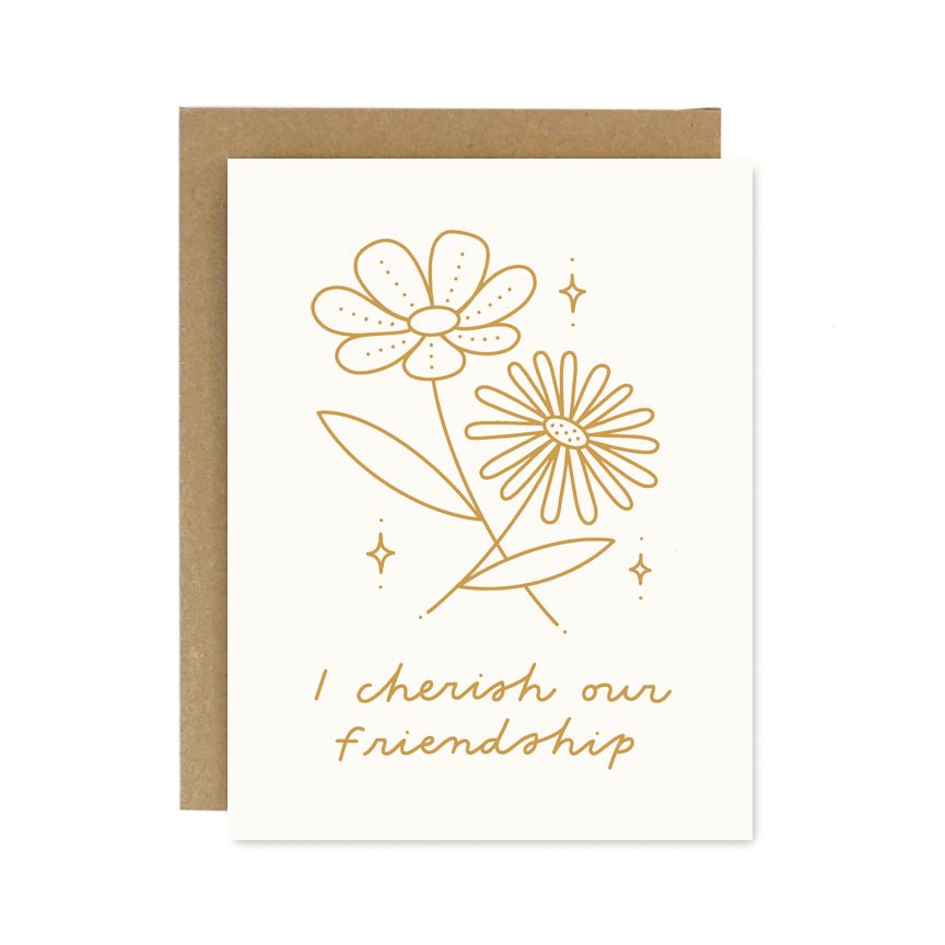 A white card with a yellow flower design. Front of card reads: "I CHERISH OUR FRIENDSHIP." Designed and handcrafted by Worthwhile Paper in Ypsilanti, MI.