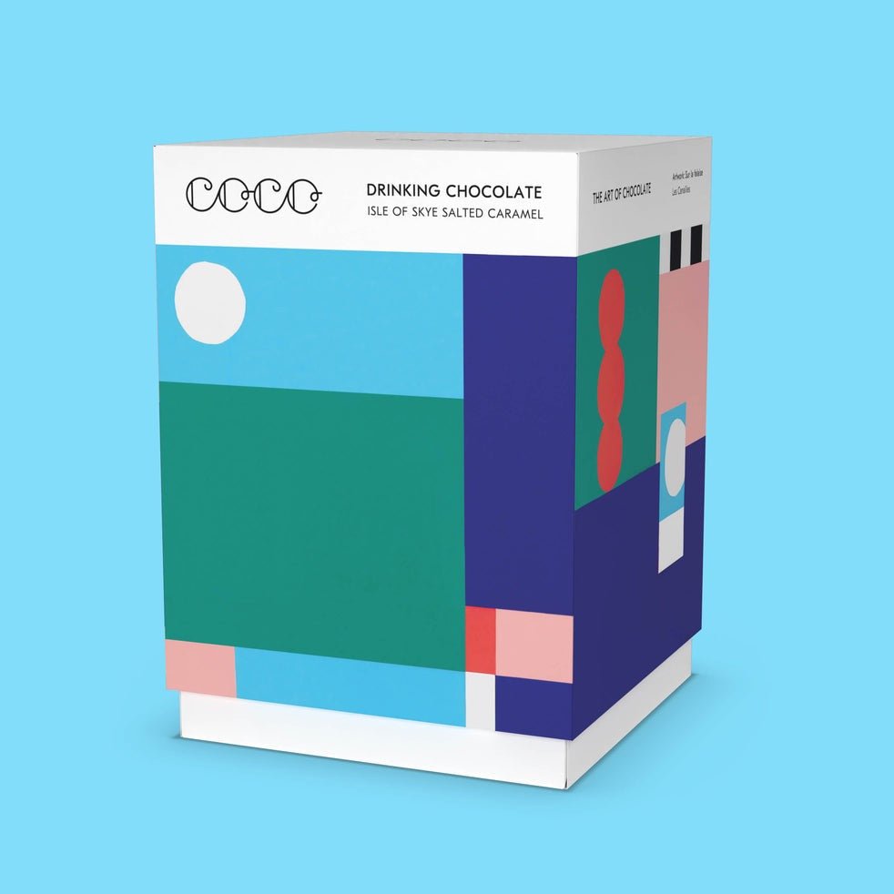 A multicolored square box holds a powdered cocoa mix. The Isle of Sky Drinking Chocolate is from COCO Chocolatier.