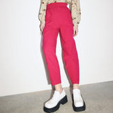 A straight leg pant in a bright pink color with an elastic waistband. The Izmir Pants in Fuchsia is designed by Eve Gravel and made in Montreal, Canada.