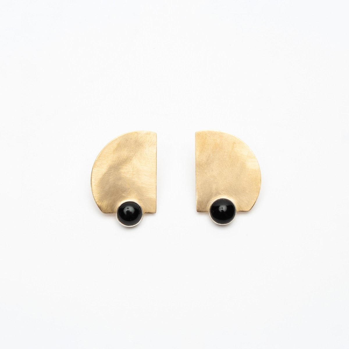 Flat brushed brass stud earrings with a Black Onyx stone setting at the bottom. Designed by Kari Phillips in Portland, Oregon.
