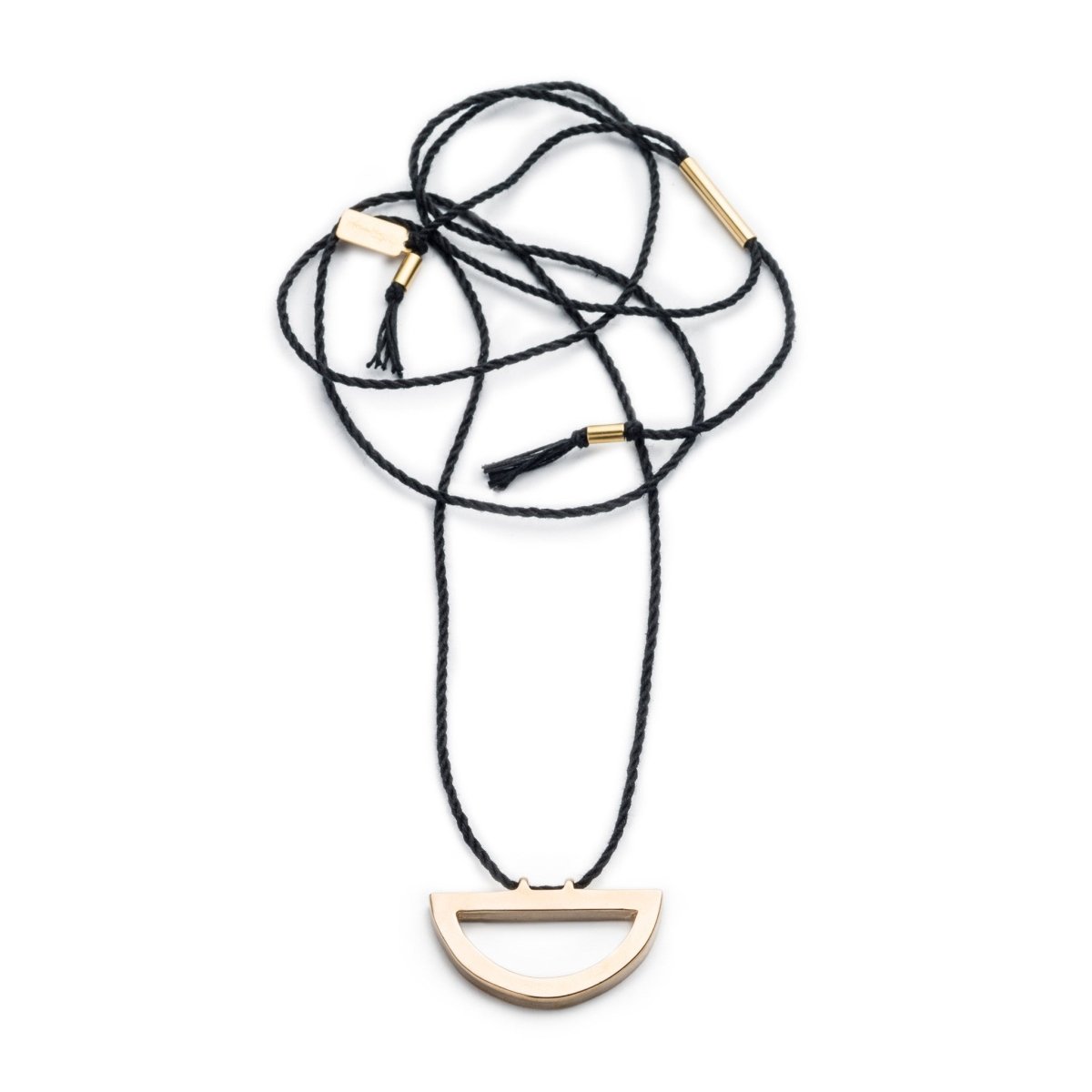 Modern, adjustable necklace of black Japanese cotton rope threaded along the long end of a cast bronze semi-circle pendant with brass tubing accents and black cotton fringe. Hand-crafted in Portland, Oregon. 