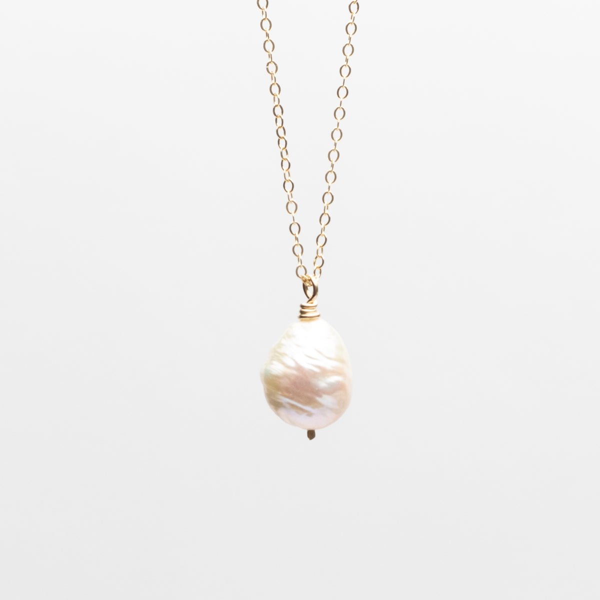 Freshwater baroque pearl hangs a the end of a 14K gold filled chain. Designed by Kari Phillips in Portland, Oregon.