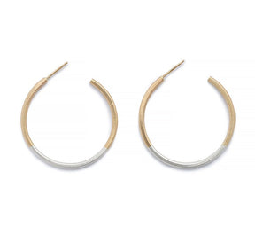 Minimalist, lightweight, mixed metal hoops of 14k yellow gold and sterling silver hand-forged wire, with 14k gold earring posts. Size small, one and one-eighth inches in diameter. Hand-crafted in Portland, Oregon.