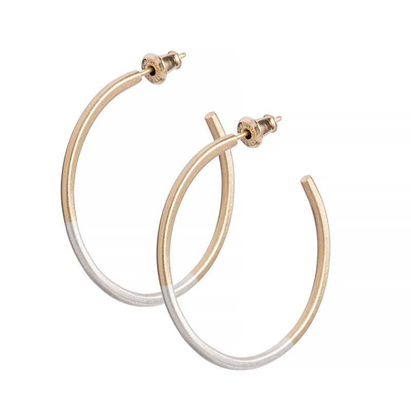 Minimalist, lightweight, mixed metal hoops of 14k yellow gold and sterling silver hand-forged wire, with 14k gold earring posts and ear nuts. Size small, one and one-eighth inches in diameter. Hand-crafted in Portland, Oregon.