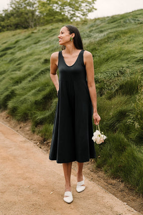 Relaxed sleeveless midi-length jumpsuit with pockets in the color True Black. The Lakeside Jumpsuit is designed by Mien and made in Los Angeles, CA.