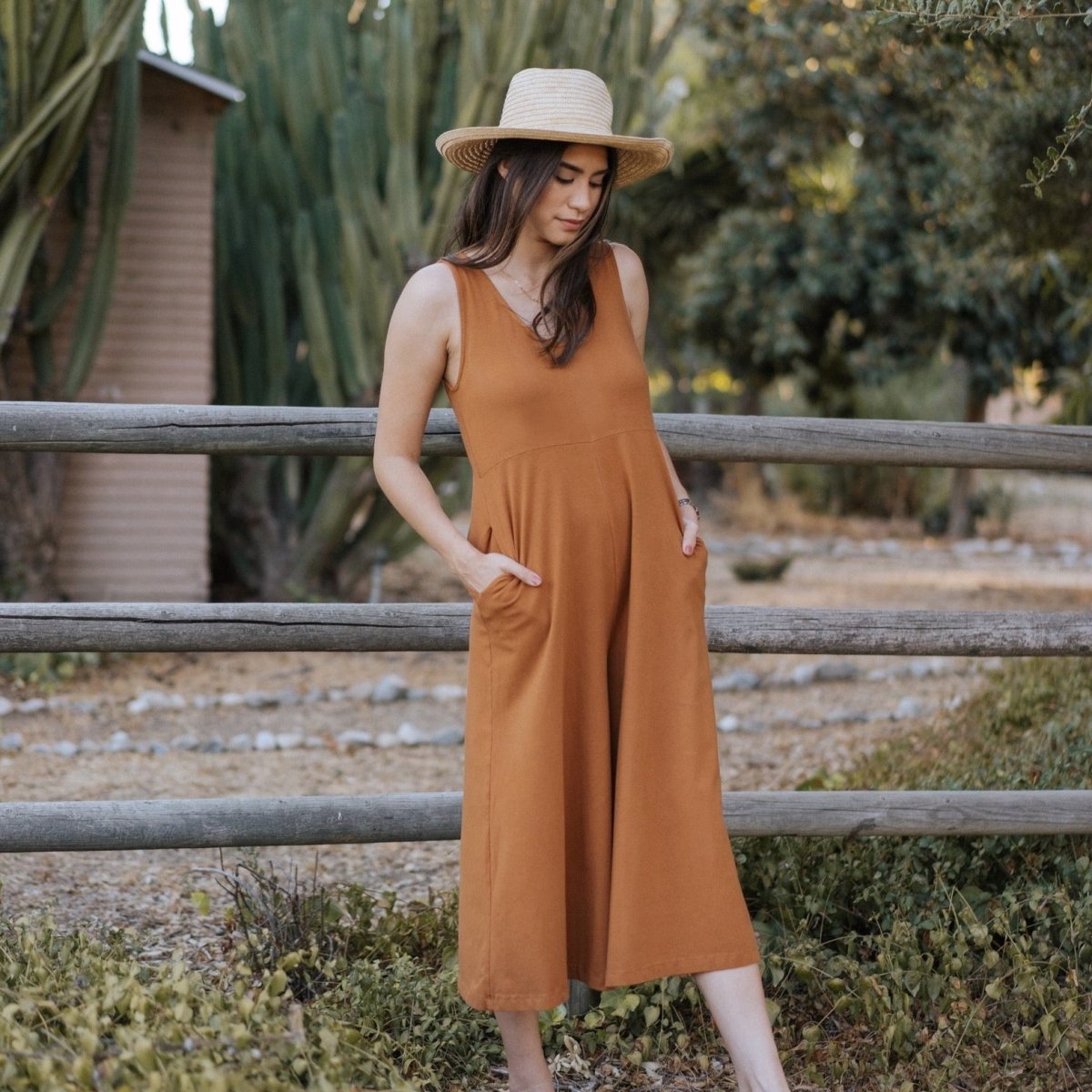 Relaxed sleeveless midi-length jumpsuit with pockets in the color Saddle Brown. The Lakeside Jumpsuit is designed by Mien and made in Los Angeles, CA.