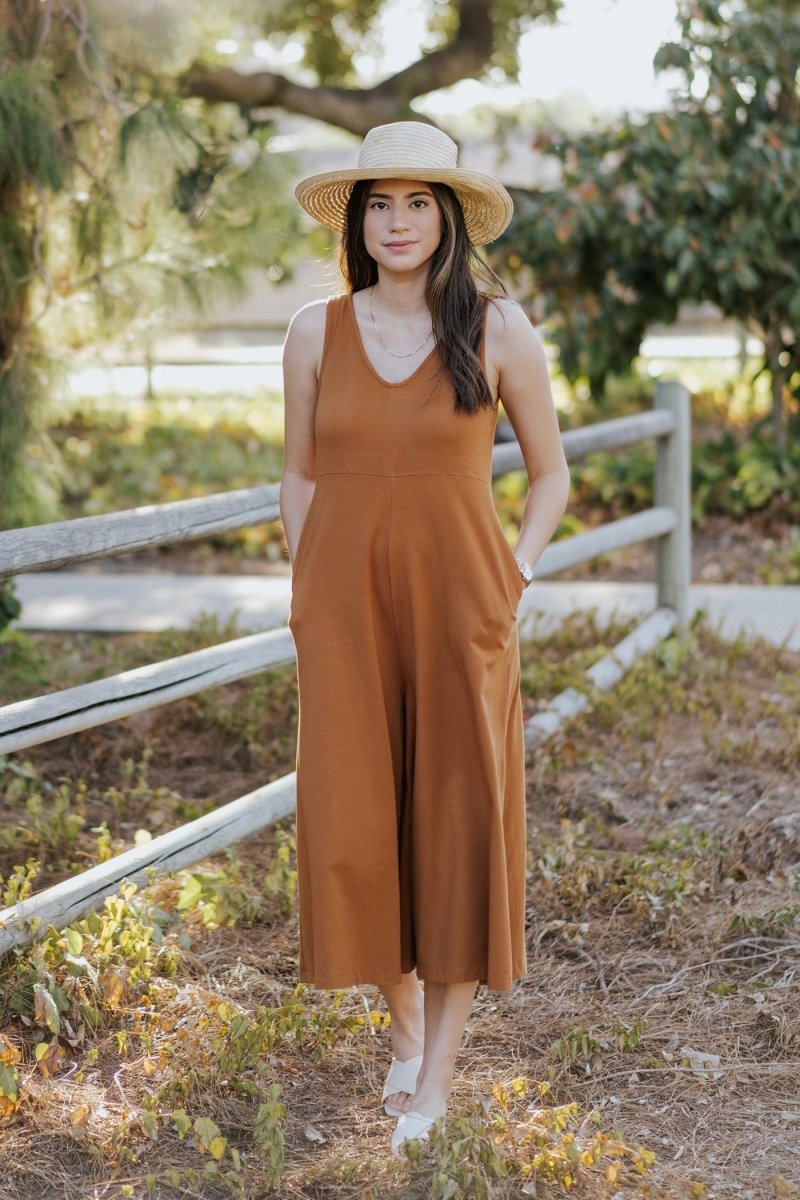 Relaxed sleeveless midi-length jumpsuit with pockets in the color Saddle Brown. The Lakeside Jumpsuit is designed by Mien and made in Los Angeles, CA.