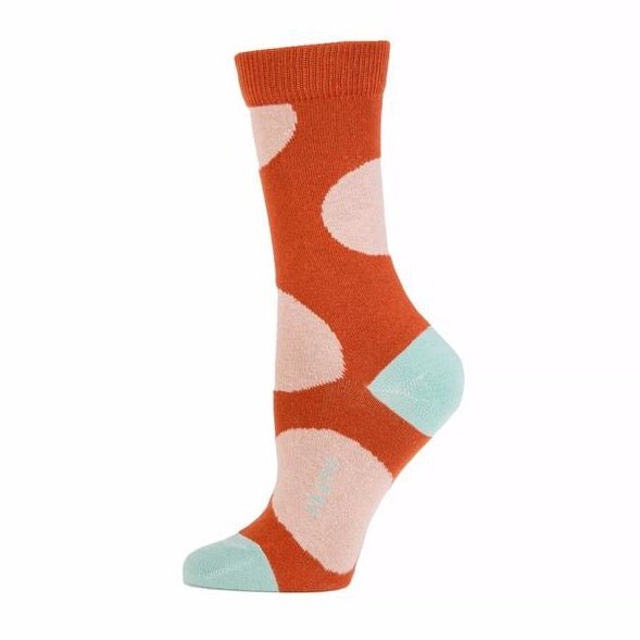 Orange sock with large light pink dot pattern and ribbed collar. Heel, toe and logo along the arch are a light blue. The Large Dot Crew Sock in Cinnamon is designed by Zkano and made in Alabama, USA.