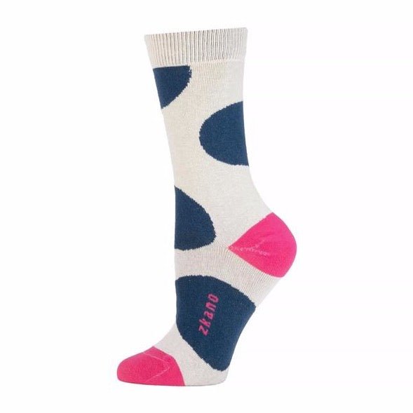 White sock with a ribbed collar and large navy blue dot pattern throughout. Heel, toe and logo along arch are in a bright fuchsia color. The Large Dot Crew Sock in Pearl is designed by Zkano and made in Alabama, USA.