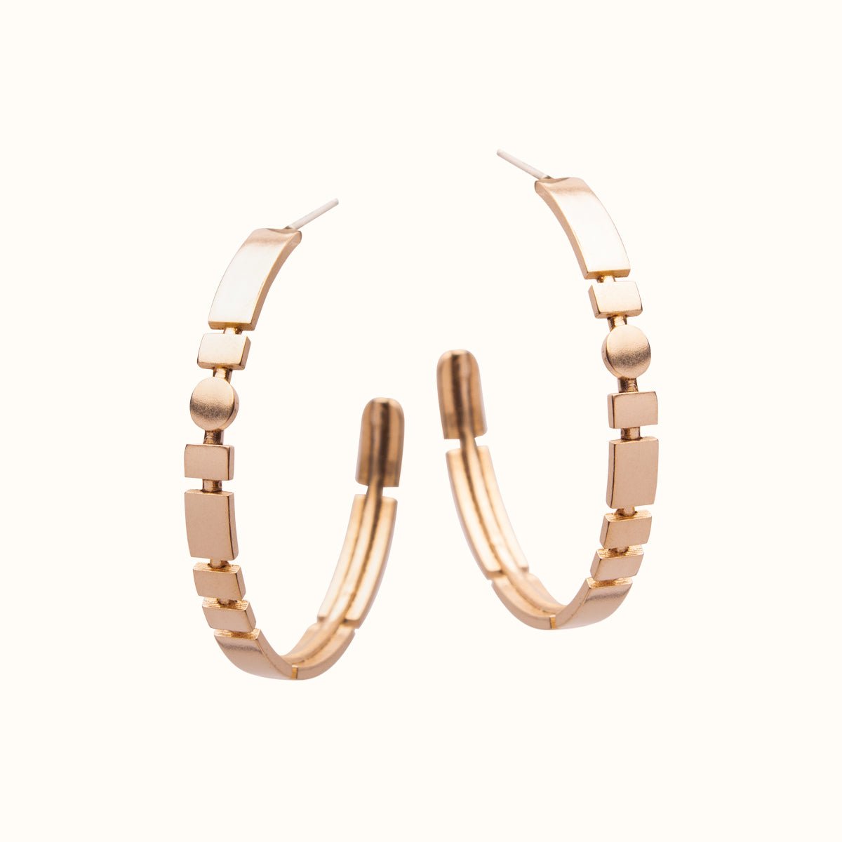 A narrow bronze hoop earring featuring alternating square and circular shapes.Designed and handcrafted in Portland, Oregon.
