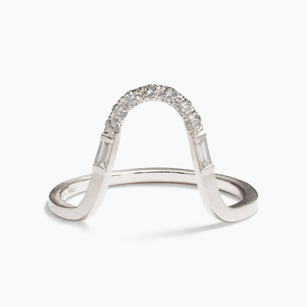Arched stacking Levo ring. Features lab-grown diamonds in a pavé setting and a 14K recycled white gold band.