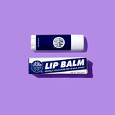 A blue and white tube of lip balm against a bright purple background. The LipJao lip balm is created by Jao Brand and made in Pennsylvania, USA.