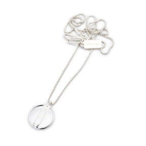 Small, open circle pendant of shiny cast silver with two vertical bars running through the center, on a sterling silver box chain with an original sterling silver clasp and a silver betsy & iya tag. Hand-crafted in Portland, Oregon.