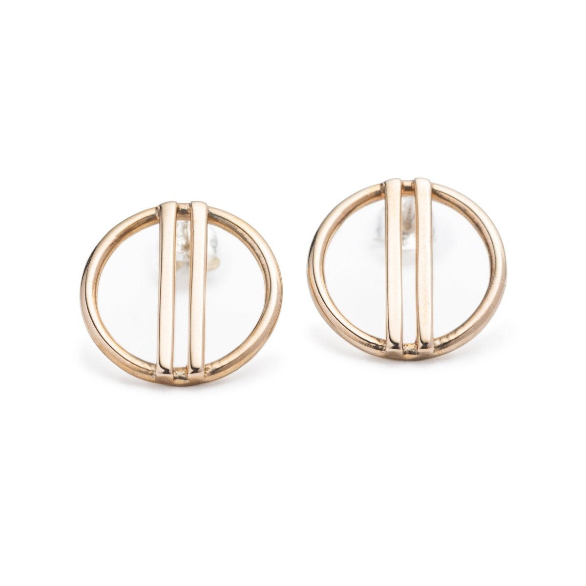 Minimal, modern, and shiny cast bronze stud earrings, featuring a small, open circle with two vertical bars running through the center. Hand-crafted in Portland, Oregon.