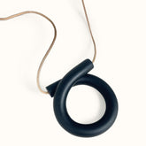 An adjustable statement necklace with an off black polymer clay focal piece in a large loop shape. The Loop Necklace in Black is designed and handcrafted by Little Pieces Jewelry in Los Angeles, CA.