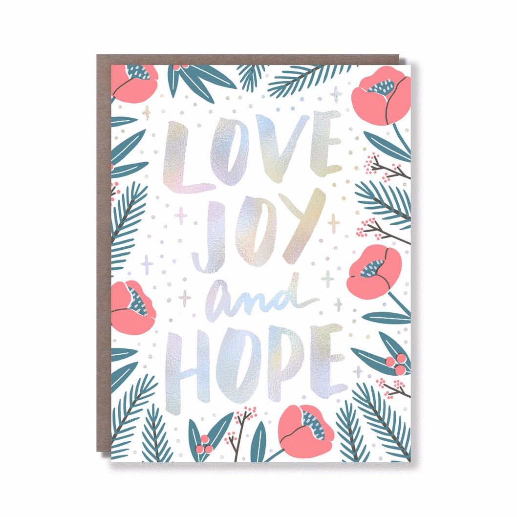 Iridescent card with florals and winter greenery along the edge. Front of card reads: "LOVE, JOY AND HOPE." Card measures 4.25 x 5.5 inches and is designed by Hello! Lucky in San Francisco, CA.