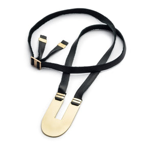 Adjustable, black leather necklace with a sleek, oblong, polished brass statement pendant, brass tubing accents, and an original betsy & iya cast bronze buckle. Hand-crafted in Portland, Oregon.