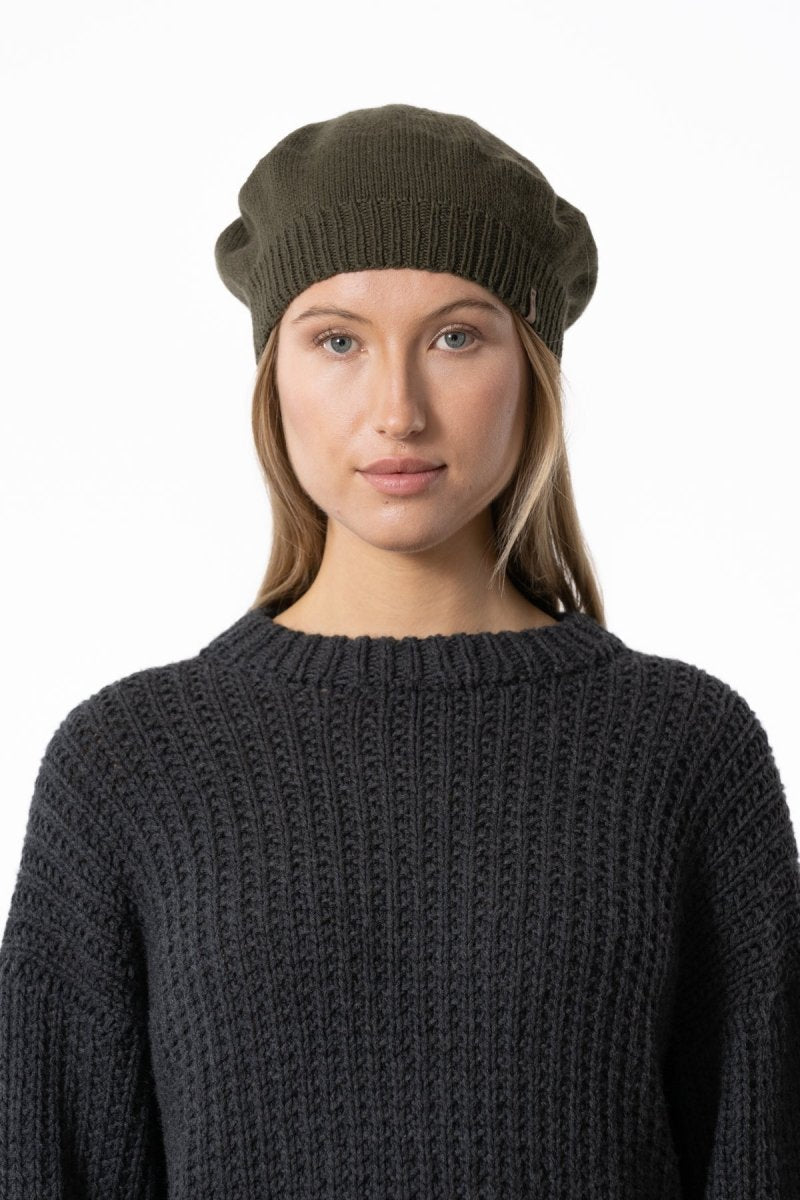 A slouch style hat with fitted ribbed collar. The Merino Beret in Olive Green is designed by Dinadi and hand knitted in Kathmandu, Nepal.