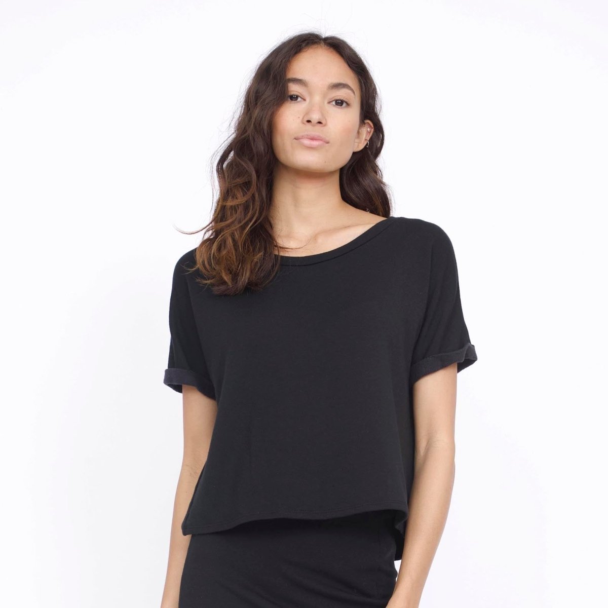 Rolled cuff tee with a slightly longer back in Black. Fabric and top made in Los Angeles, CA by Corinne Collection.