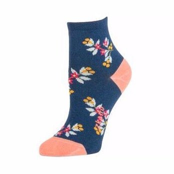 Navy blue sock with orange, blue and pink floral pattern with the Zkano logo along the arch. Heel and toe are a light pink. The Mae Anklet in Blue Jean is from Zkano and made in Alabama, USA.