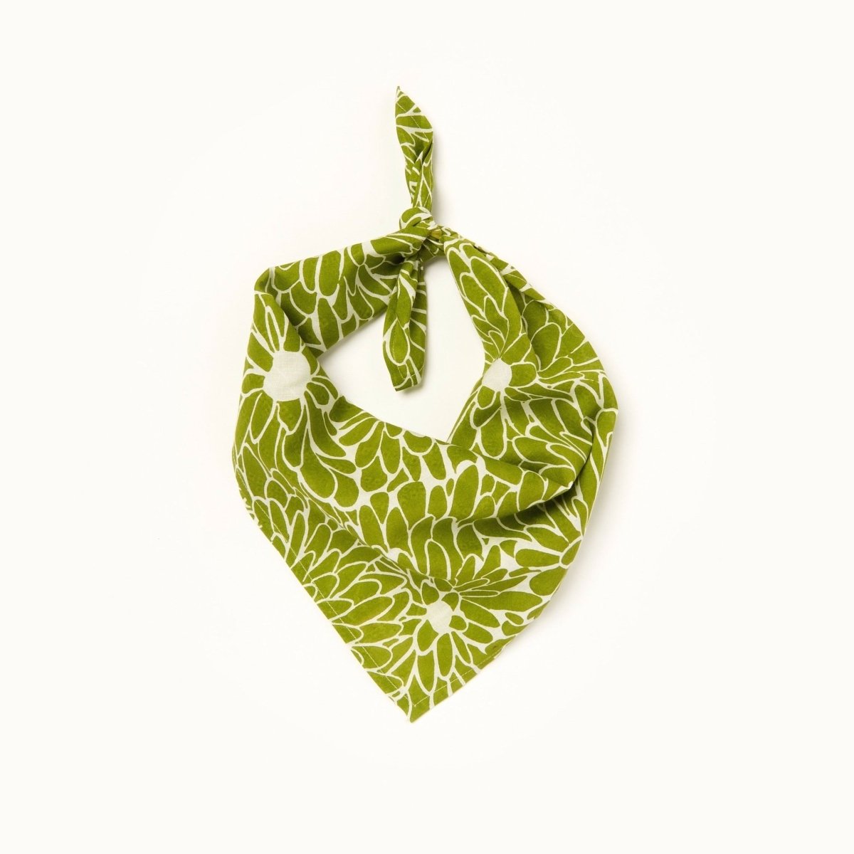 A green and white patterned bandana, folded over and tied in a knot. Block printed by hand, the Coco Bandana from Maelu is designed in Portland, Oregon and handmade in India.
