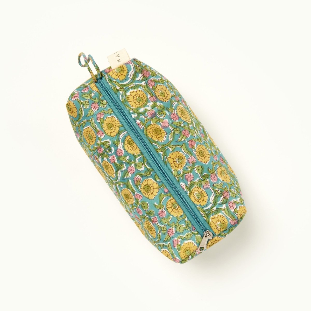  A green, blue, yellow and pink floral patterned makeup bag. The Fiona Makeup Bag from Maelu is designed in Portland, Oregon and printed in India.