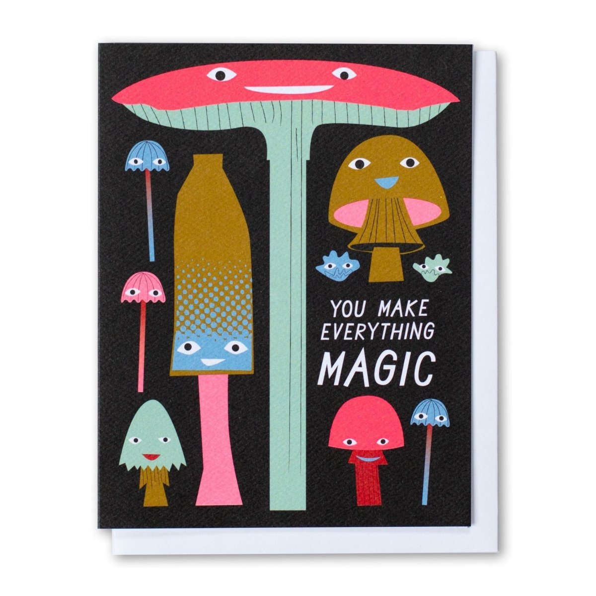 A black greeting card with pink, green, red, blue and brown mushroom illustrations. Front of card reads: "YOU MAKE EVERYTHING MAGIC." Made with recycled paper by Banquet Atelier in Vancouver, British Columbia, Canada.