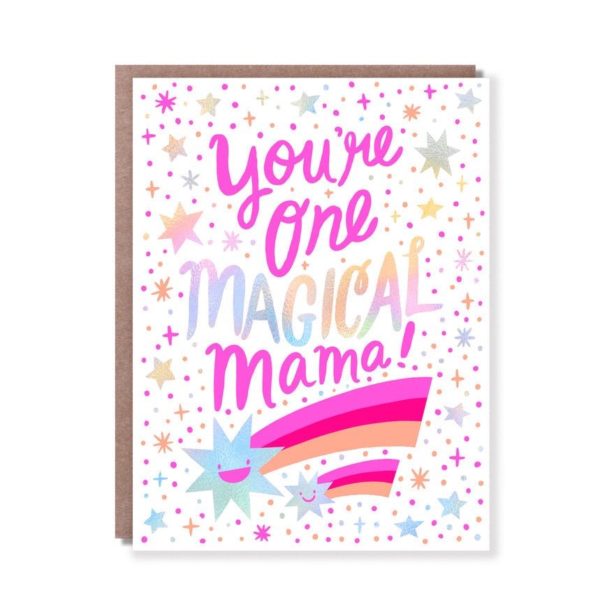 Front of card reads: "YOU'RE ONE MAGICAL MAMA." A white greeting card with pink, yellow and orange two shooting star and iridescent celestial illustrations. Designed by Hello! Lucky and made in San Francisco, CA. Measures 4.25 x 5.5 inches.